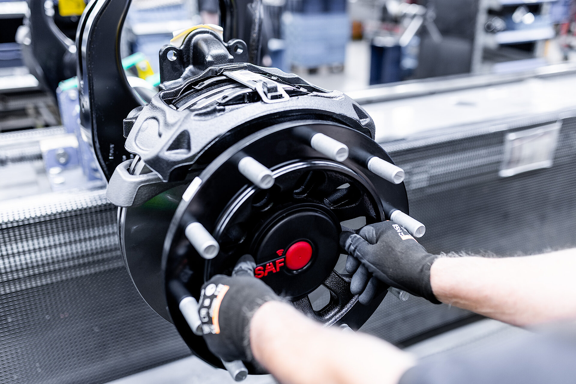 Installation of a SAF-branded hub cover on an axle assembly.